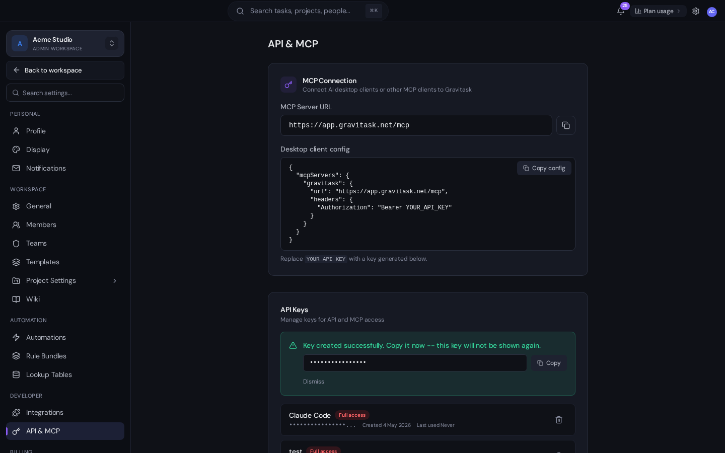 Gravitask API key creation success banner with the secret value redacted to bullets and a Copy button